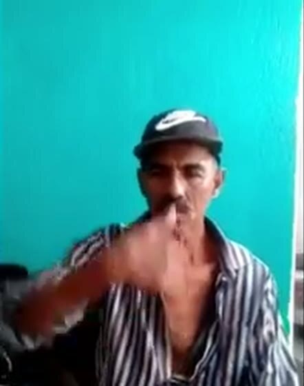 Javier seated at home, lifting and extending his arm.